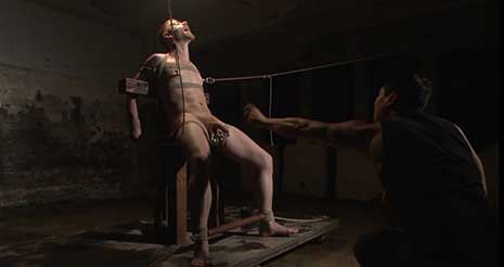 THE CHAIR - Cody Winter is secured to a wooden chair before Van Darkholme beats his tight body. Cody’s screams echo across the dark room, only to be drowned out by the loud smack of a....