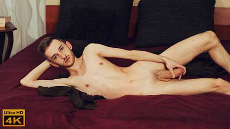 Robert Smola lives in Brno. He is a student who enjoys sports, cycling and jogging. He sits on the bed and does his interview. Then he takes off his tee shirt, as directed.