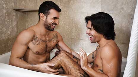 Ian Greene and Ty Mitchell playfully splash each other as they take a bath together. The pair dry off, and Ian pulls off Ty's towel and swats at his ass with it, then gets to his knees and rims his juicy peach.